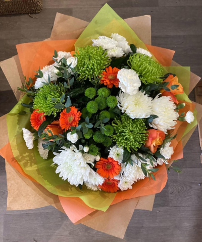 Citrus Sunrise - Capture the essence of a golden meadow with this stunning bouquet of yellow, white, and orange flowers. Presented in a stylish packaging it's perfect for adding natural beauty to any space