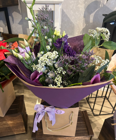 Violet Whisper - A serene bouquet of lilac and purple blooms with soft white accents and fresh greenery, hand-arranged for a gentle, elegant floral gift.